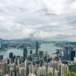 A breathtaking aerial panorama of Hong Kong's iconic skyline with towering skyscrapers and Victoria Harbour.