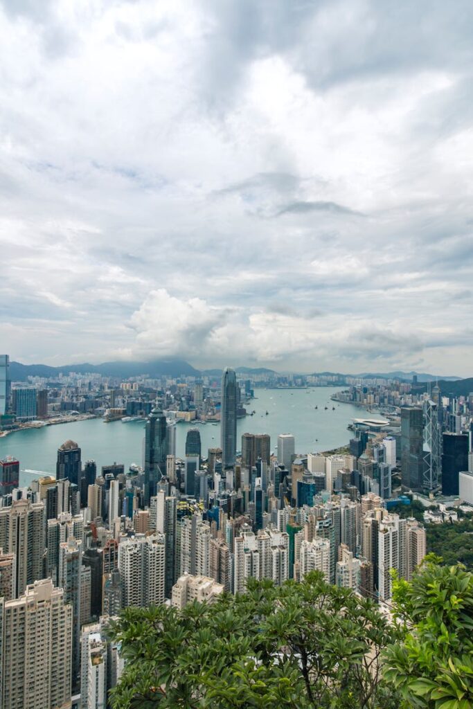 A breathtaking aerial panorama of Hong Kong's iconic skyline with towering skyscrapers and Victoria Harbour.